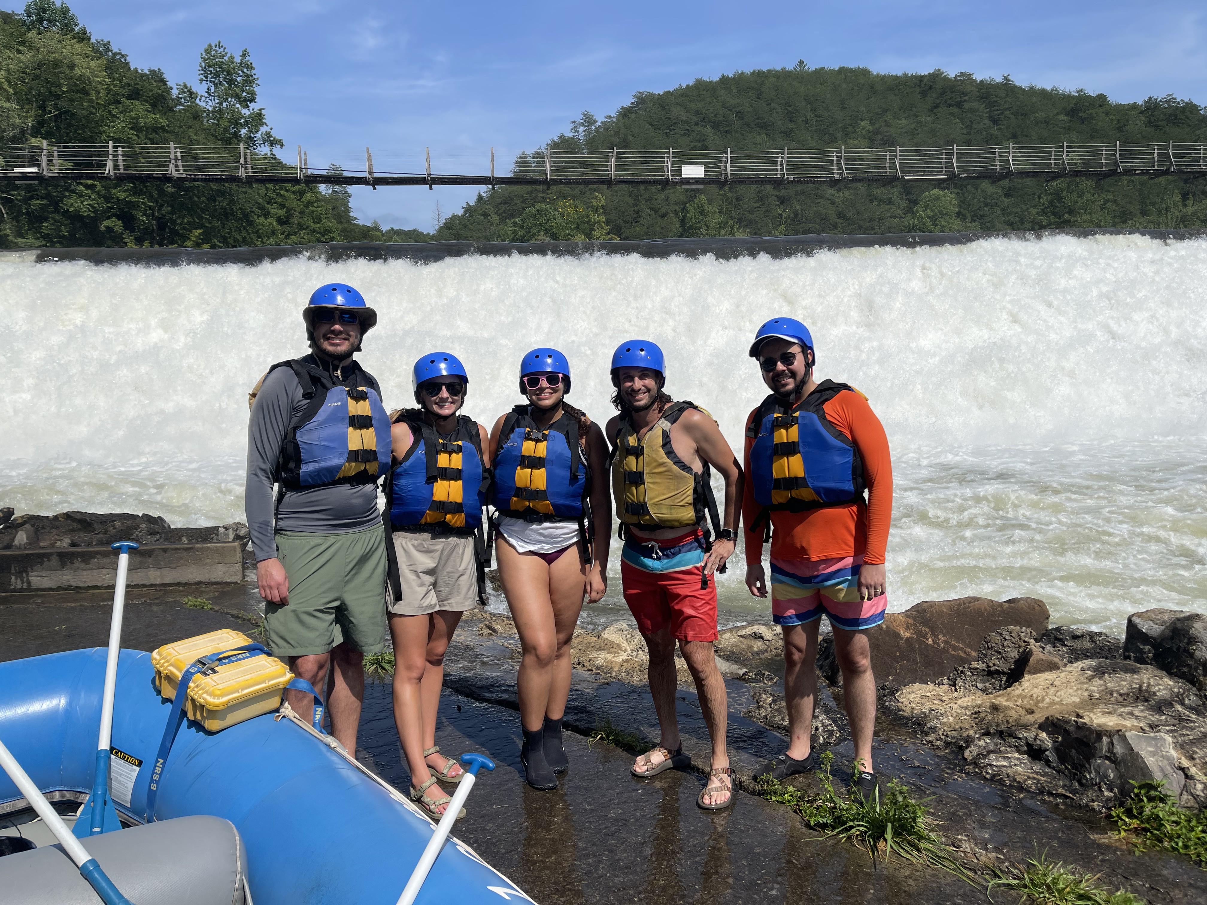 four students smiling before going white water rafting