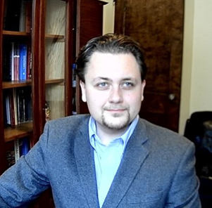 Headshot of Chistophe Combemale sitting in an office.