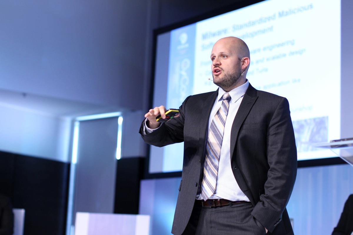 Photo of Trey Herr speaking at an event.